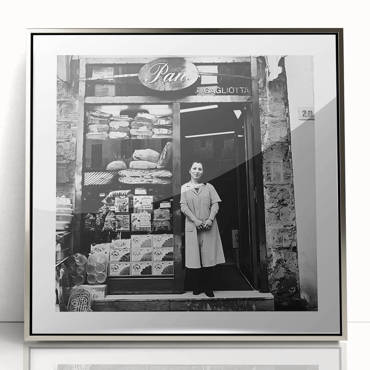 Mid-century modernist art featuring people dining, in muted earth tones, acrylic print in a silver frame.