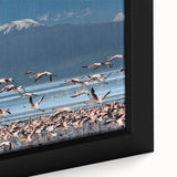 Close-up of textured black wall art depicting the African scenery in vibrant colors on a framed canvas.