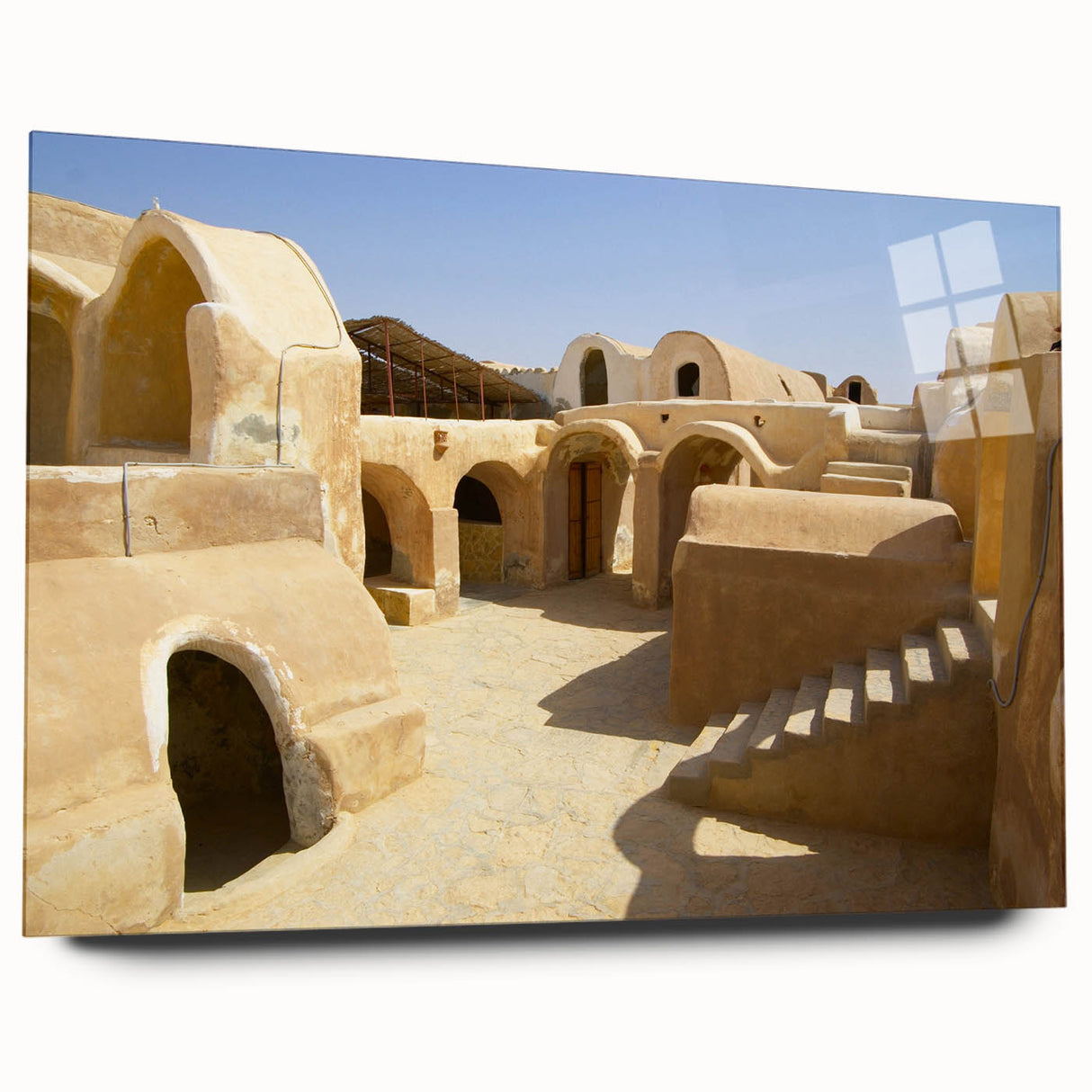Large abstract wall art of a Moroccan landscape in muted earth tones on acrylic glass.