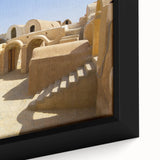 Black wall art featuring a textured Moroccan landscape on a framed canvas, with colorful art elements.