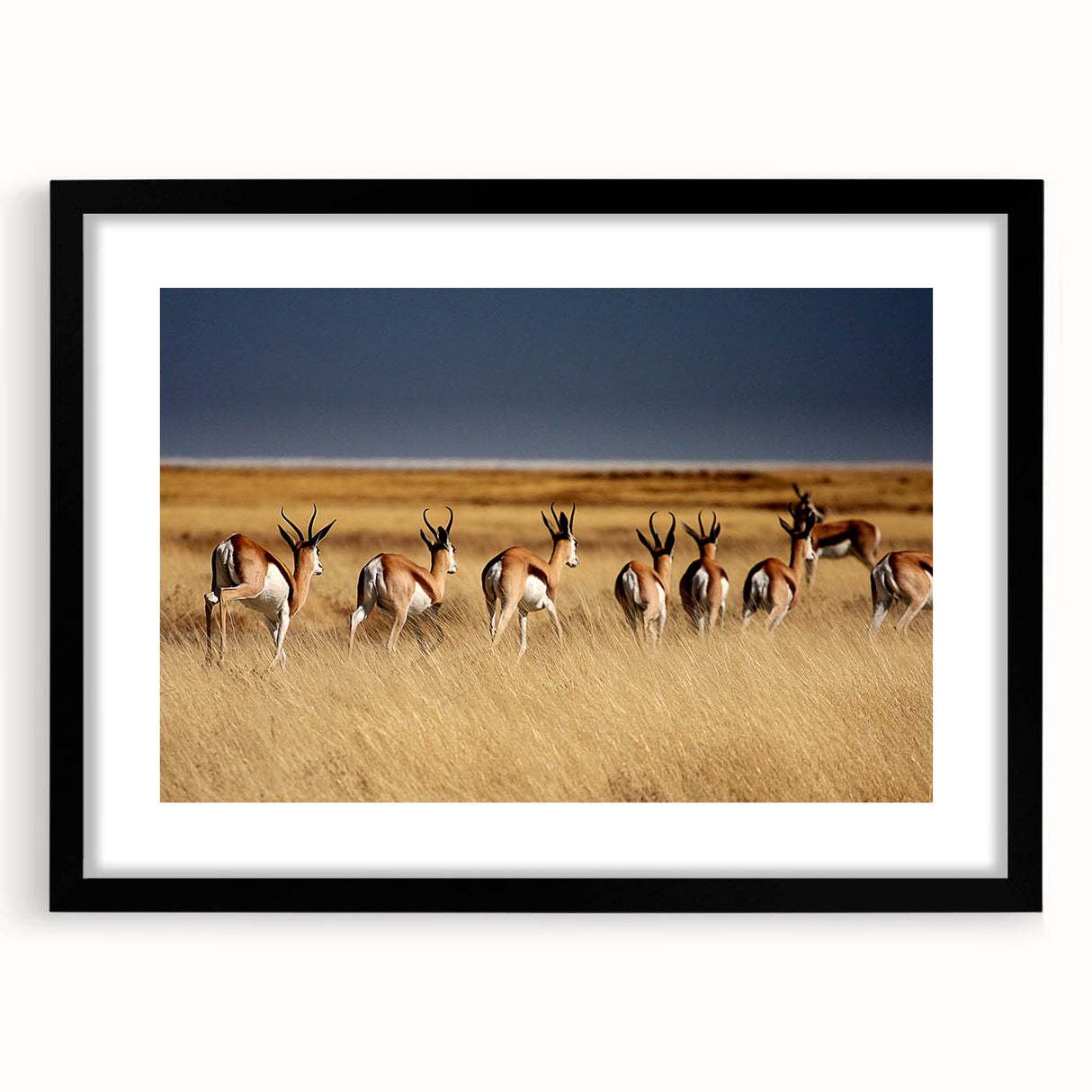 Extra large abstract art print of African scenery in vibrant colors on textured canvas, framed in black.