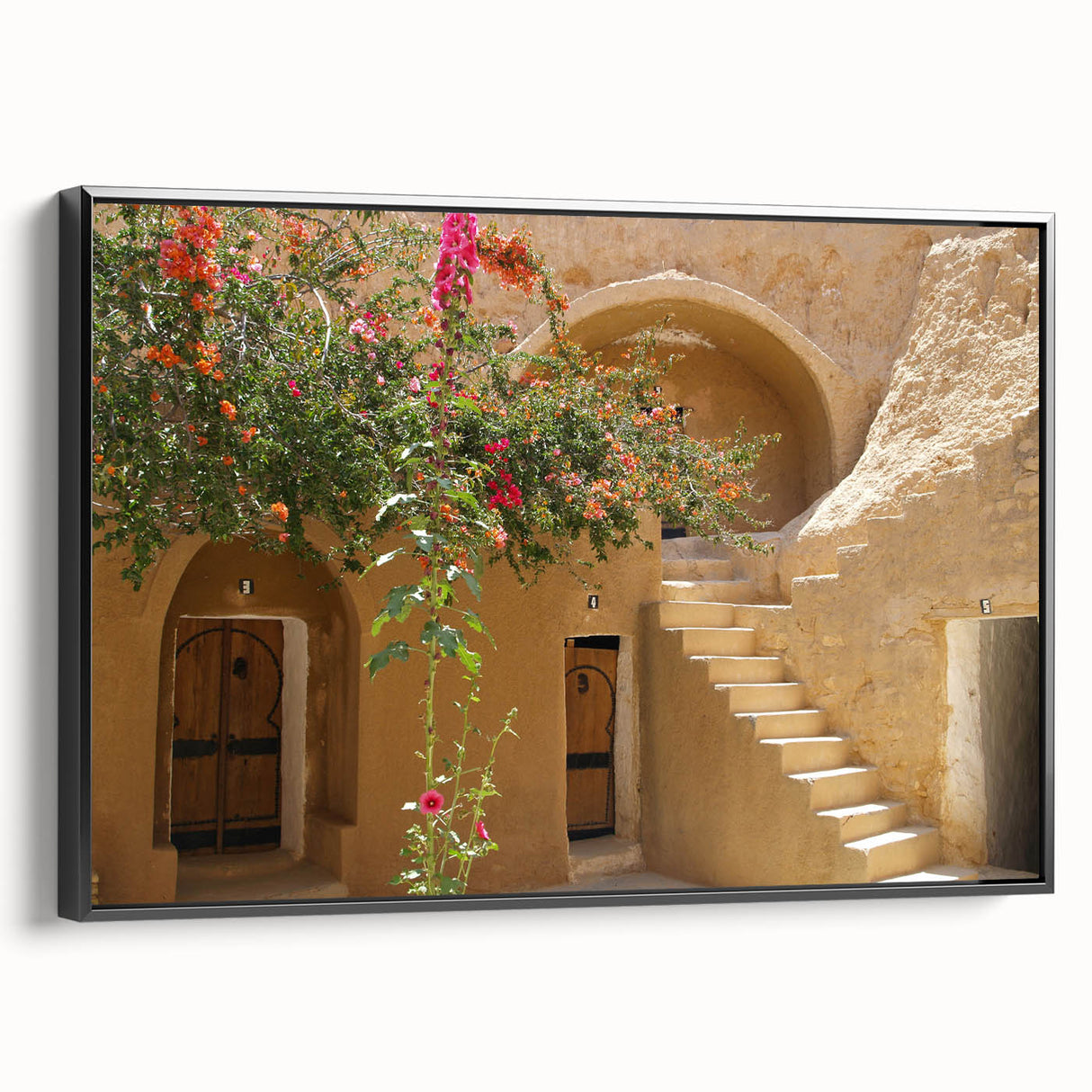 Framed canvas featuring a black and white landscape of Tunisia, suitable as wall art for a bedroom.
