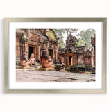 Textured art depicting an abstract Cambodian landscape in muted earth tones, framed in silver, ideal for bedroom ambiance.