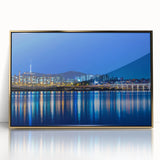 Acrylic print of Seoul skyline with gold frame, featuring mid-century modernist design and soft pastel colors.
