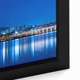 Framed canvas of a colorful, textured depiction of the Seoul skyline, in a black and vibrant color palette.