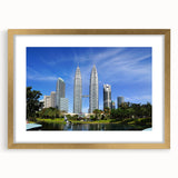 Extra large abstract art print of a Malaysian landscape in textured hues of gold and green, framed with a gold mat.