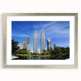 Textured abstract art print of a Malaysian landscape in muted earth tones on a silver-framed canvas.