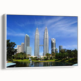 Vintage poster art of a Malaysian landscape on a framed canvas, featuring vibrant colors against a black background.