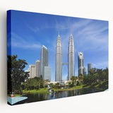 Side view of a stretched canvas depicting a serene Malaysian landscape in muted green and blue tones.