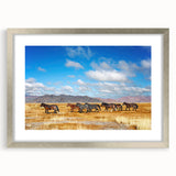 Textured art print featuring abstract Mongolian scenery in muted earth tones, framed in silver, ideal for bedroom decor.