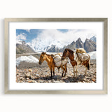 Textured art print depicting abstract scenery in earth tones, framed in silver, suitable for bedroom decor.