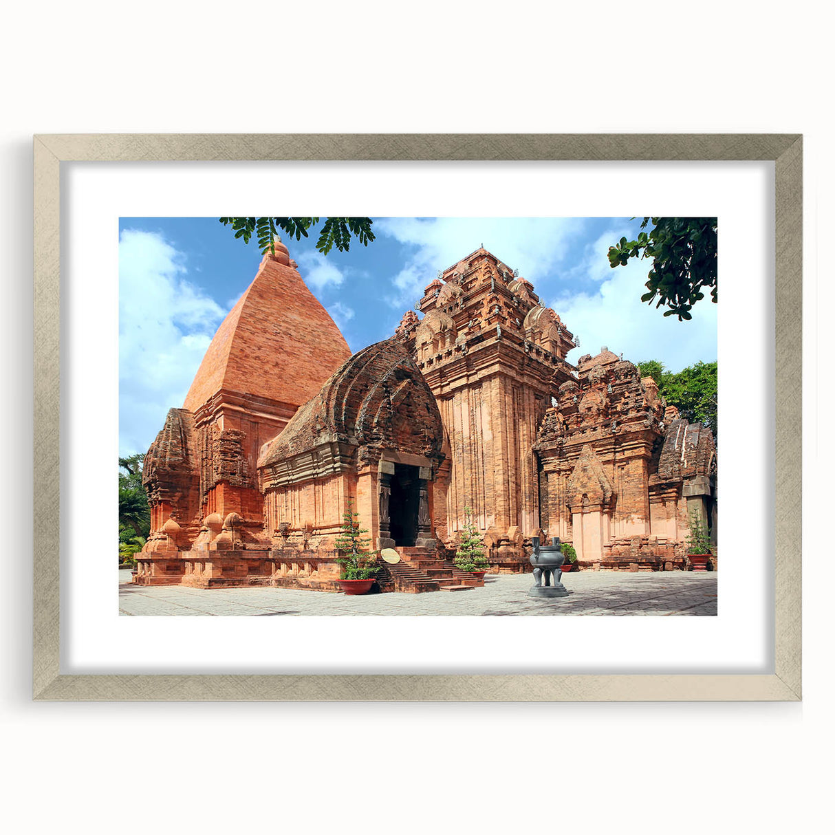 Textured abstract art print depicting a Vietnamese landscape in muted green and brown tones, framed in silver.