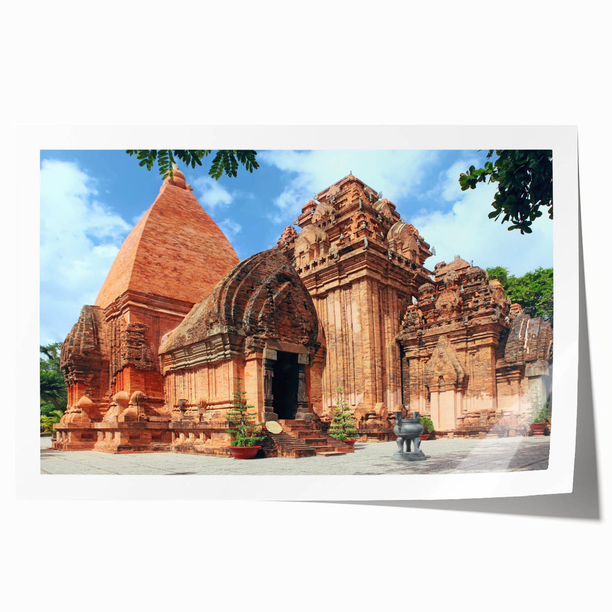 Rolled canvas print of a Vietnamese landscape featuring lush greenery and a river, in soft green and blue tones.