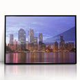 Large abstract wall art depicting Brisbane skyline in muted gray and blue tones, acrylic print framed in black.