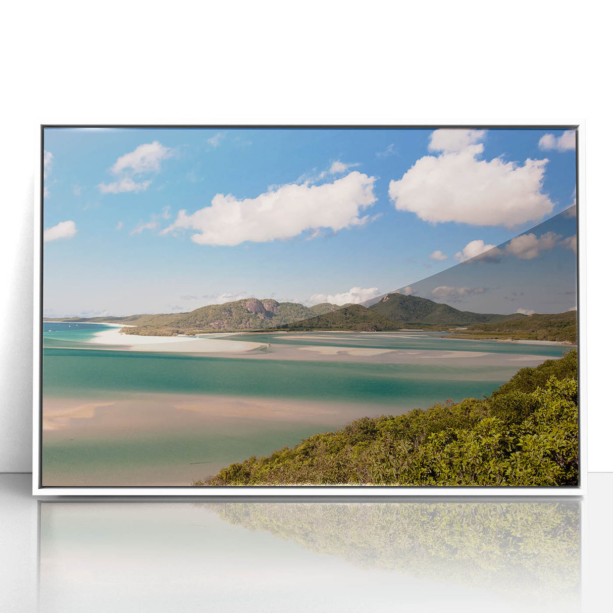 Large art print of the Great Barrier Reef on white framed acrylic, featuring vibrant blue and green tones.