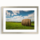 Textured art print of an abstract depiction of New Brunswick scenery in muted earth tones, framed with a silver mat.