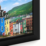 Close-up of a textured black wall art featuring a colorful Newfoundland scenery on a framed canvas.