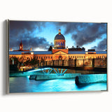 Framed canvas depicting a vintage-style landscape of Quebec, featuring colorful art on a black background.
