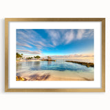 Abstract art print of Caribbean scenery in gold frame, featuring vibrant blue and green tones, ideal for dining room decor.