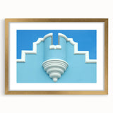 Abstract art print of a Caribbean landscape in muted blue and green tones, framed in gold, ideal for dining room decor.