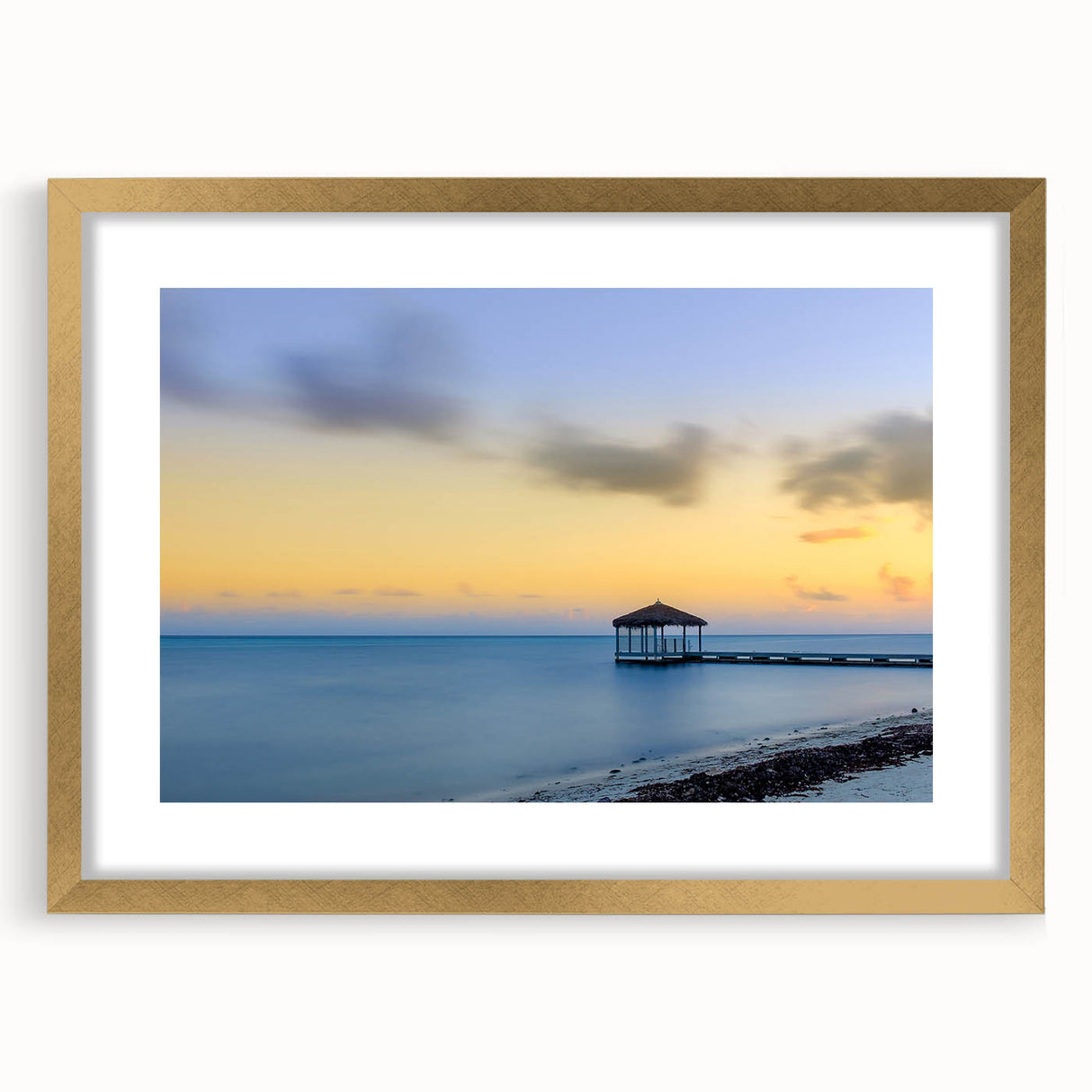 Textured abstract art print depicting Caribbean scenery in vibrant blue and green hues, framed in gold.
