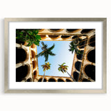 Extra large abstract art print of a Caribbean scenery, in muted blue and green tones, framed in silver.