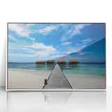 Mid-century modernist style acrylic print of a Caribbean scenery in vibrant blues and greens, framed in white.