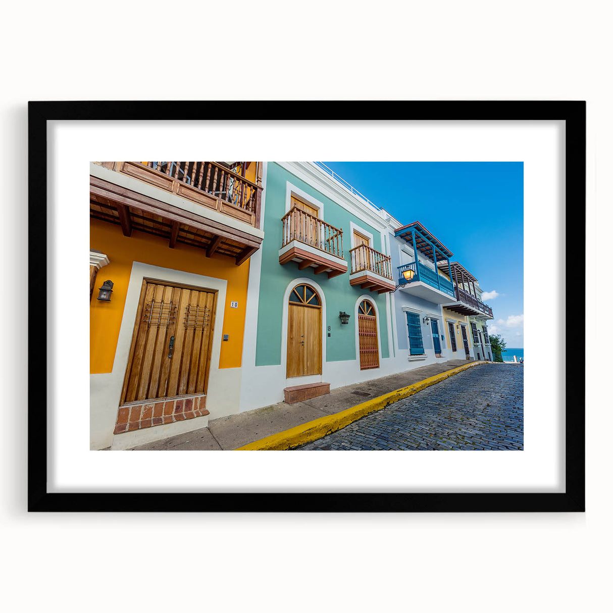 Abstract art print of a vibrant Caribbean scenery in textured colors, framed in black, ideal for living room decor.