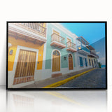 Large abstract wall art depicting a Caribbean scene in muted blue and green tones, framed in black acrylic.