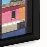 Close-up of a textured, extra-large framed canvas featuring a colorful Central American scenery, ideal for living room decor.