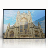 Large abstract wall art depicting a European scenery in muted earth tones, framed in black acrylic.