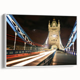 Vintage poster art of London scenery on a framed canvas, featuring colorful landmarks on a black background.