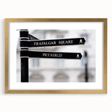 Abstract art print of Piccadilly, England in muted gold tones on a framed mat, suitable for dining room decor.