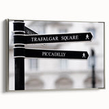 Framed canvas of a vintage European landscape painting with a silver frame, featuring colorful art on a black background.