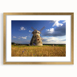 Abstract art print of a European landscape in muted earth tones on a gold-framed canvas, suitable for dining room decor.