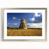 Extra large abstract art print of a textured European scenery in muted earth tones, framed in silver.