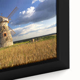 Close-up of a black framed canvas depicting a textured European scenery with vibrant, colorful art.