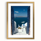 Abstract art print of Santorini landscape in gold frame, featuring cool blue and white tones, ideal for dining room decor.