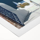 Art deco poster of Santorini landscape on rolled canvas, featuring white buildings and blue sea, ideal for dining room decor.