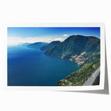 Rolled print of the Amalfi Coast with vivid blue ocean and colorful cliffside houses, ideal for dining room decor.
