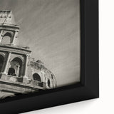 Close-up of a black framed canvas depicting the Colosseum in Italy with a textured finish, featuring colorful art.