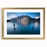 Abstract art print of Lake Como with muted blue and green palette, framed in gold, ideal for dining room decor.