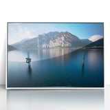 Mid-century modernist art of Lake Como with muted blue and green tones on a white framed acrylic.