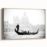 Framed canvas featuring a vintage-style landscape painting of Venice in muted gold and black tones.