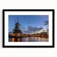 Abstract art print of Amsterdam scenery in colorful, textured style on a large black-framed canvas.
