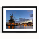Abstract art print of Amsterdam scenery in colorful, textured style on a large black-framed canvas.
