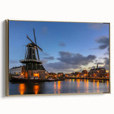 Framed canvas featuring a vintage-style landscape painting of Amsterdam with muted gold and black tones.