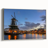 Framed canvas featuring a vintage-style landscape painting of Amsterdam, with vibrant colors and black accents.