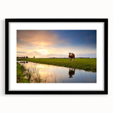 Abstract art print of a colorful European scenery in vibrant hues on a large textured canvas, framed in black.