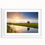 Textured art print of abstract scenery featuring earthy and blue tones on a white framed mat, ideal for modern bedroom decor.